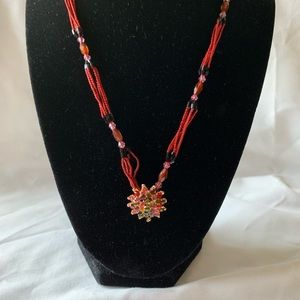 Lovely beaded necklace with coloured rhinestone pendant.